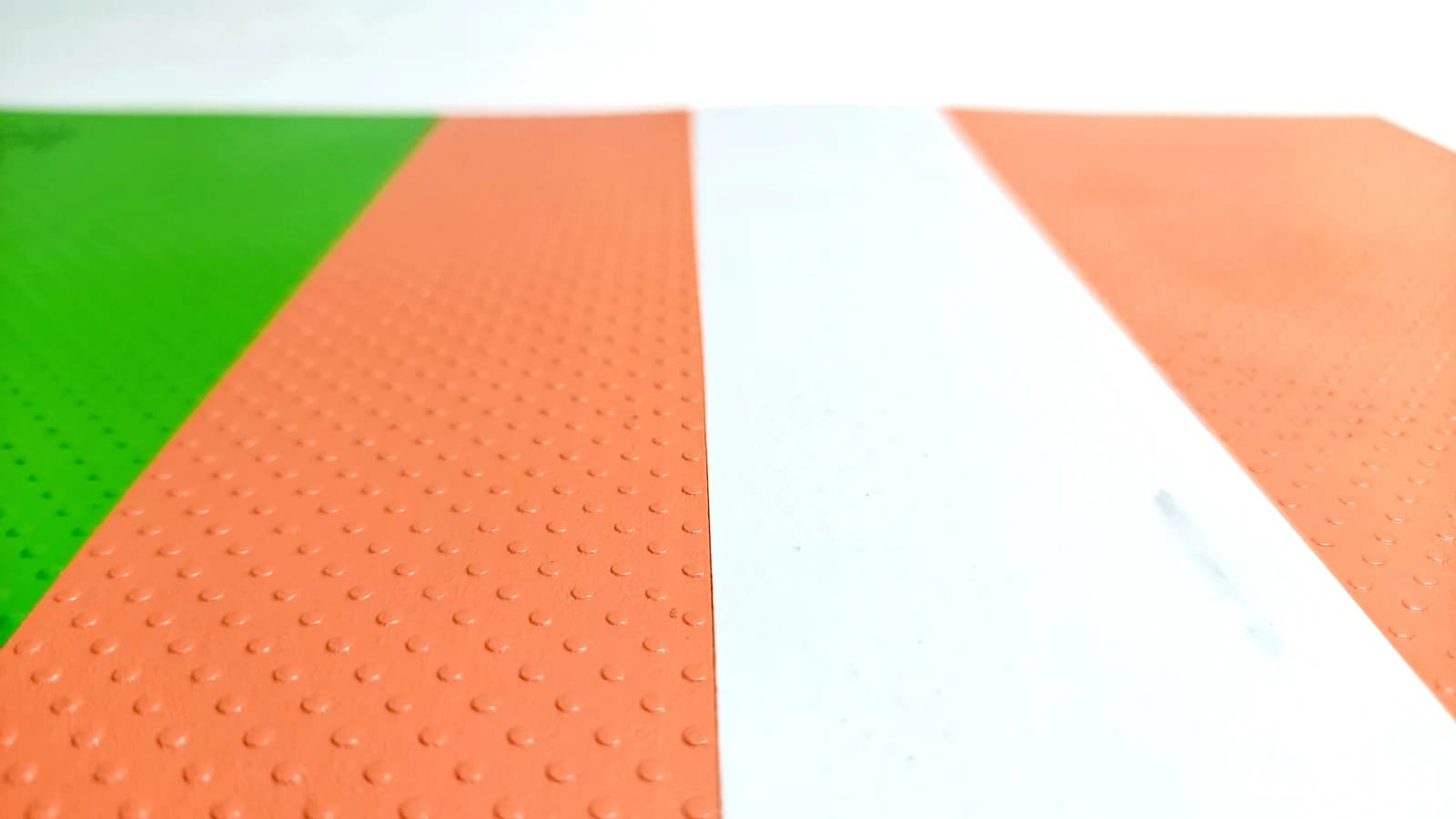 Close view of the glow band running beside the dot-pattern anti-skid surface of an auto-glow mat